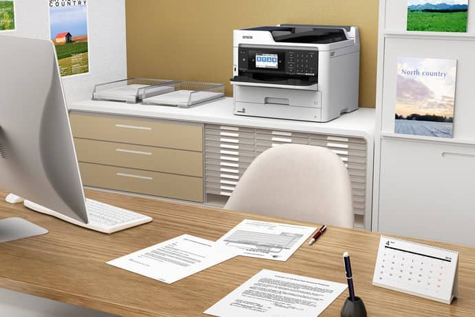 epson desktop a4 printer sat in an office environment next to a desk